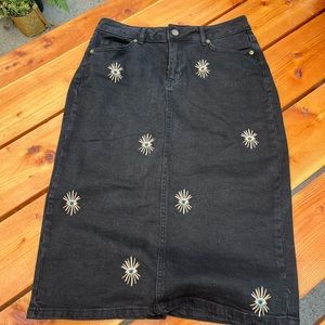 Denim skirt with “evil eye” embroidery detail